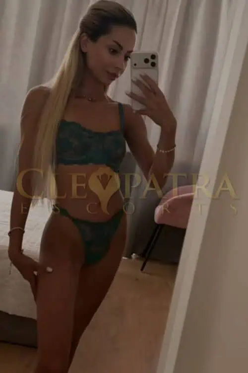 London escort taking mirror selfie in lingerie for Daikiri post.